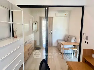 Modern apartment interior with sliding glass doors and minimalist furniture