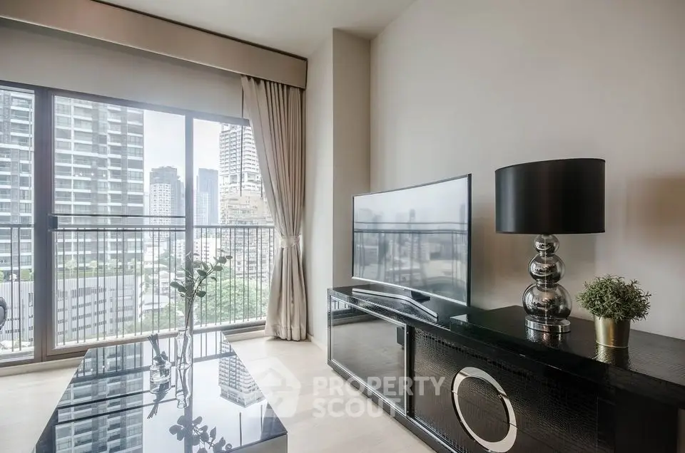 Modern living room with large windows and city view, featuring sleek furniture and elegant decor.