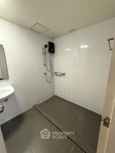 Modern minimalist bathroom with white tiles and walk-in shower
