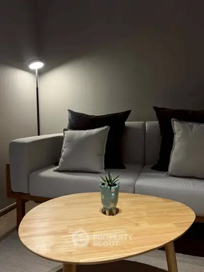 Stylish modern living room with cozy sofa and elegant wooden coffee table.