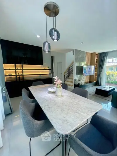 Modern open-plan living and dining area with stylish decor and natural light.