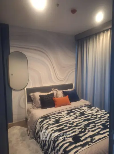 Stylish bedroom with modern decor and cozy bedding in a contemporary apartment.