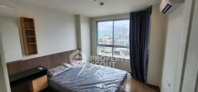 Modern bedroom with large window offering city view, featuring minimalist design and air conditioning.