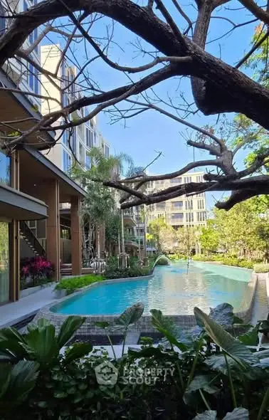 Luxurious residential pool with lush greenery and modern architecture