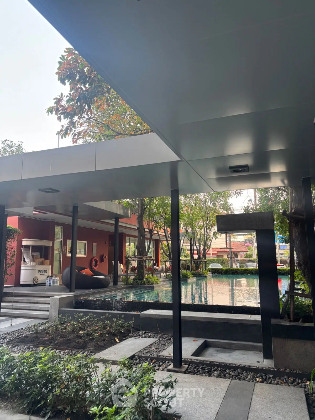 Modern outdoor pool area with sleek design and lush greenery