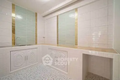 Modern kitchen with sleek tiles and ample storage space