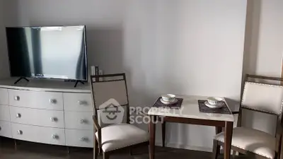 Modern living room with stylish furniture and flat-screen TV, perfect for cozy evenings.