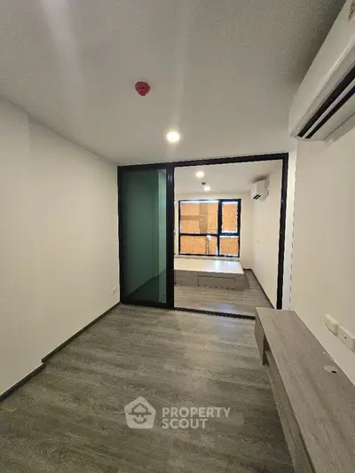 Modern apartment interior with sleek flooring and glass partition