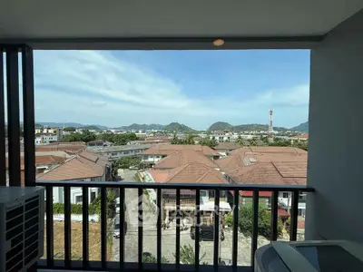 Stunning balcony view overlooking cityscape and mountains, perfect for relaxation and enjoying the scenery.