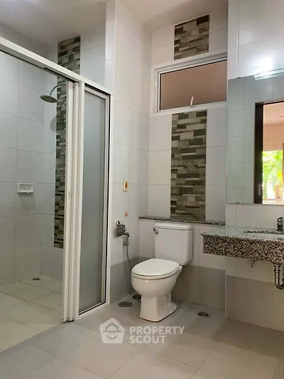 Modern bathroom with sleek shower and stylish tile accents, perfect for a contemporary home.