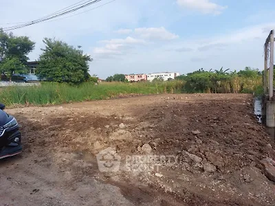 Vacant land plot ready for development in a serene suburban area with lush greenery.