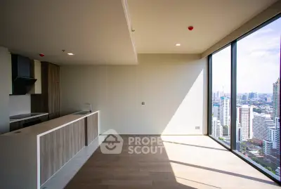Modern open-plan kitchen with stunning city view from floor-to-ceiling windows.