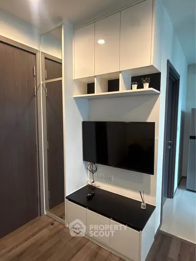 Modern living room with sleek TV setup and stylish storage solutions