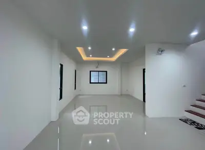 Spacious modern living room with recessed lighting and glossy flooring