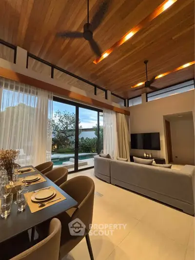 Luxurious living room with high ceilings, modern decor, and stunning outdoor view.