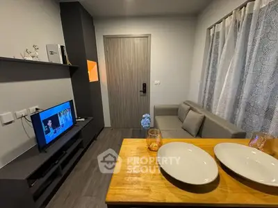 Modern living room with cozy sofa and TV, perfect for relaxation.