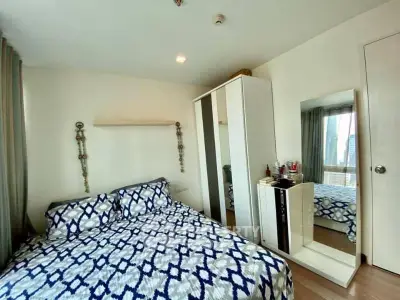 Cozy bedroom with stylish decor and ample natural light