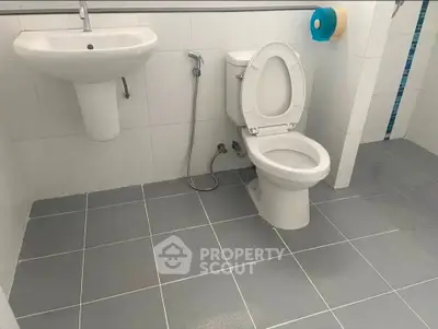 Modern bathroom with sleek fixtures and tiled flooring