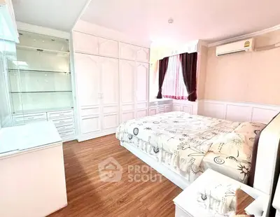 Spacious bedroom with elegant built-in wardrobes and natural light