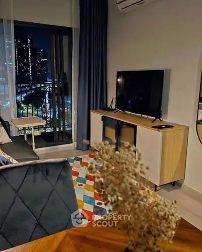 Stylish living room with city view, modern furniture, and vibrant decor.