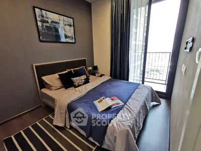 Cozy bedroom with modern decor and balcony access in a stylish apartment.