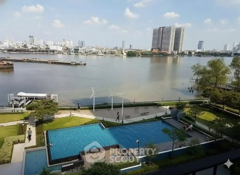 Stunning riverside view with pool and cityscape, perfect for luxury living.