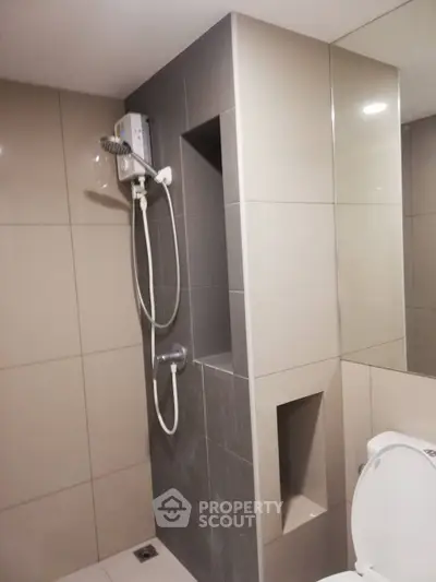 Modern bathroom with sleek shower and neutral tiles