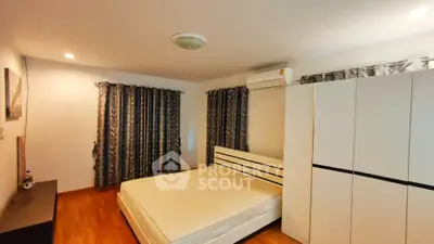Spacious bedroom with modern decor and ample natural light