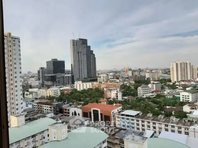 Stunning cityscape view from high-rise apartment showcasing urban skyline and modern architecture.