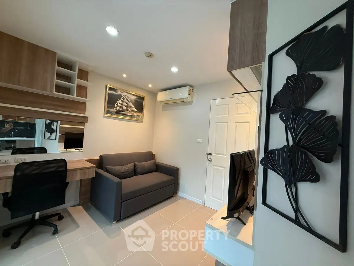 Modern living room with sleek furniture and wall art, featuring a cozy sofa and stylish decor.