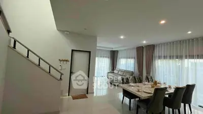 Spacious modern living room with elegant dining area and natural light