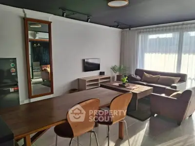 Stylish living room with modern furniture and large windows for natural light.