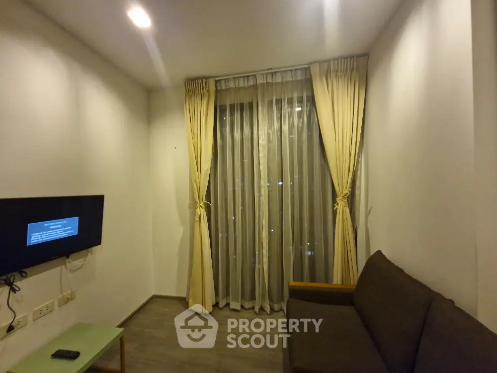 Cozy living room with modern decor and large window curtains