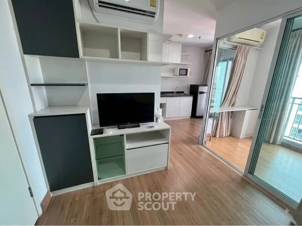 Modern apartment interior with open layout, featuring a cozy living area and sleek kitchen.