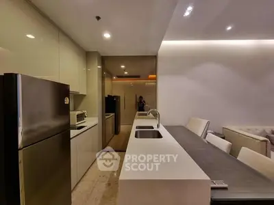 Modern kitchen with sleek design and integrated appliances in open layout