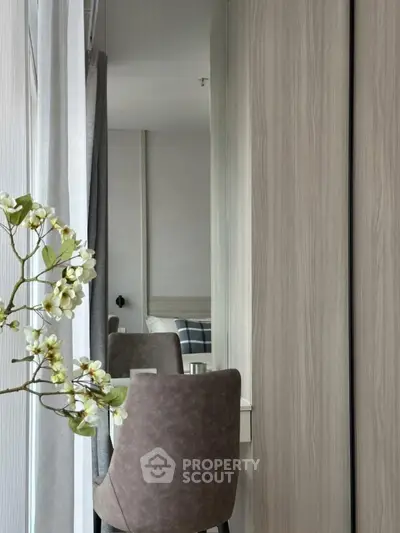 Modern bedroom with stylish decor and elegant chair by the window, perfect for relaxation.