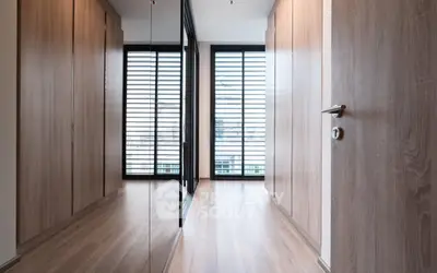 Modern hallway with wooden flooring and large mirrored closet doors