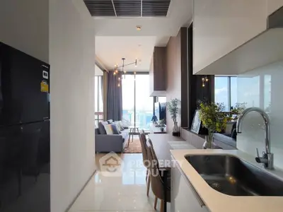 Modern open-layout kitchen and living room with city view, sleek design and natural light.