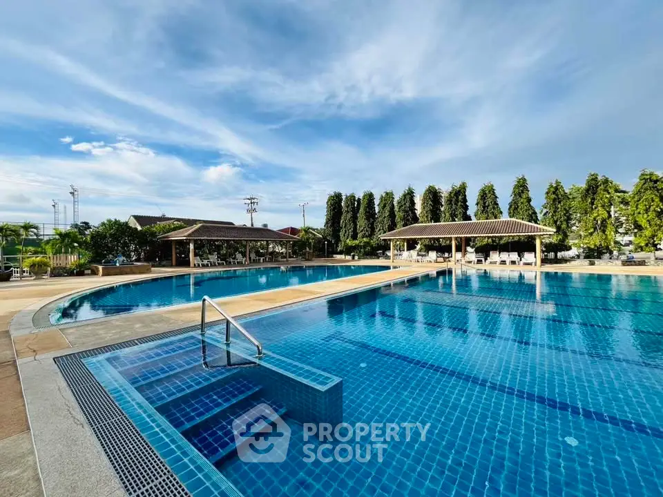 Luxurious outdoor pool with clear blue water and elegant surroundings, perfect for relaxation and leisure.