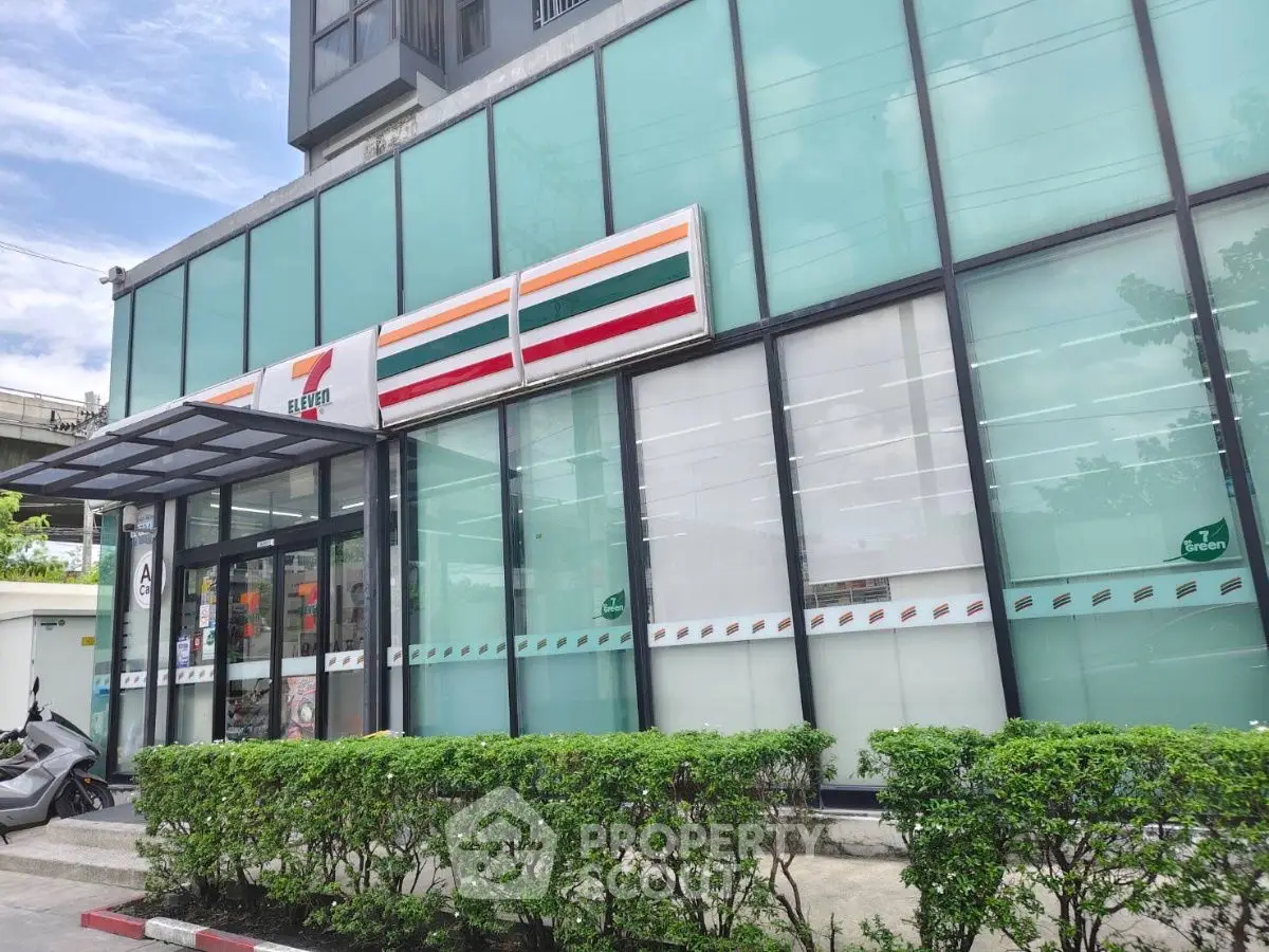 Modern commercial building with glass facade and greenery, ideal for retail business.