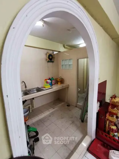 Compact utility room with sink and storage space, ideal for efficient home organization.