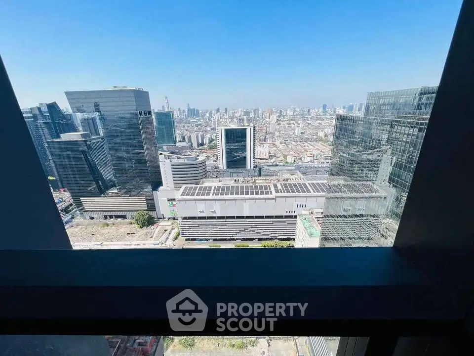 Stunning cityscape view from high-rise building window showcasing urban skyline.