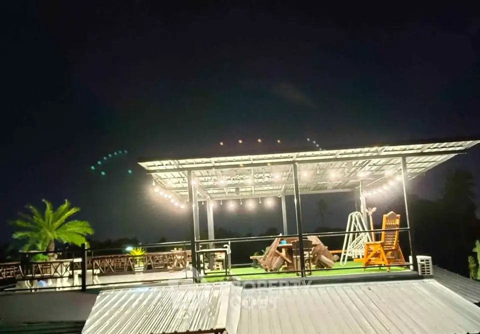 Stunning rooftop terrace with ambient lighting and outdoor seating at night.