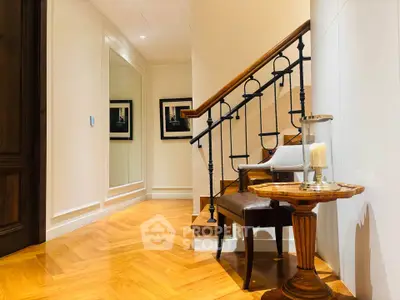 Elegant hallway with wooden staircase and stylish decor in luxury home