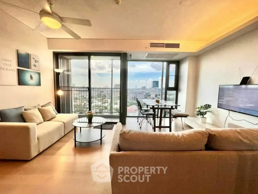 Spacious living room with modern decor and stunning city view, perfect for urban living.