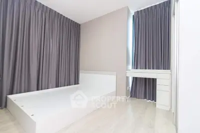 Modern minimalist bedroom with sleek white furniture and floor-to-ceiling curtains.