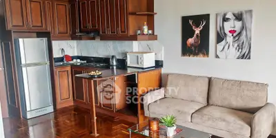 Charming kitchen and living room with wooden cabinets and cozy sofa, perfect for modern living.