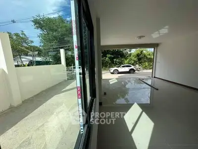 Spacious modern living room with large windows and natural light