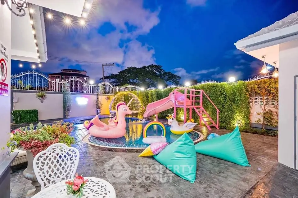 Luxurious outdoor pool area with vibrant inflatables and stylish seating, perfect for entertaining and relaxation.
