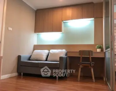 Modern living room with cozy sofa and built-in desk, perfect for urban living.